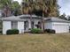 One-story home with palm trees and attached garage at 11577 Sw 72Nd Cir, Ocala, FL 34476