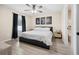 Comfortable bedroom with a ceiling fan, neutral colors, and natural light from the large window at 12 Pine Trace Pl, Ocala, FL 34472