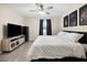 Spacious bedroom with king-size bed and ceiling fan, and views to backyard at 12 Pine Trace Pl, Ocala, FL 34472