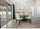 Dining area with glass table, chairs, and sliding glass doors that flood the room with natural light at 12 Pine Trace Pl, Ocala, FL 34472