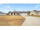 Newly built home with a 1-car garage and driveway at 12 Pine Trace Pl, Ocala, FL 34472