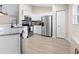 Modern kitchen with stainless steel appliances, granite countertops, and white cabinetry at 12 Pine Trace Pl, Ocala, FL 34472
