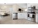 Bright kitchen with stainless steel appliances and an open layout connected to the adjacent dining area at 12 Pine Trace Pl, Ocala, FL 34472