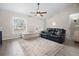 Living room with sectional sofa, ceiling fan and hardwood floors at 12 Pine Trace Pl, Ocala, FL 34472