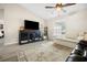 Living room with sectional sofa, dog kennel, and large TV at 12 Pine Trace Pl, Ocala, FL 34472