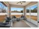 Relaxing screened porch with comfortable seating overlooking the backyard and vinyl privacy fence at 12 Pine Trace Pl, Ocala, FL 34472