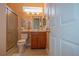 Clean bathroom with a shower, toilet, and vanity at 12955 Se 93Rd Cir, Summerfield, FL 34491