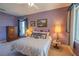 Bedroom with a queen-size bed and elegant decor at 12955 Se 93Rd Cir, Summerfield, FL 34491