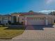 Single-story home with a three-car garage and attractive landscaping at 12955 Se 93Rd Cir, Summerfield, FL 34491