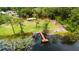 Aerial view of lakefront property and dock at 13055 Ne 7Th Loop, Silver Springs, FL 34488