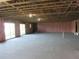 Unfinished basement featuring open ceiling beams, concrete flooring, and pink insulation at 13055 Ne 7Th Loop, Silver Springs, FL 34488