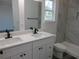 Bright bathroom featuring double sink vanity, modern fixtures, and tiled walk-in shower at 13055 Ne 7Th Loop, Silver Springs, FL 34488