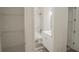 Clean bathroom with white vanity, bathtub, and grey flooring at 13055 Ne 7Th Loop, Silver Springs, FL 34488