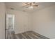 Spacious bedroom with ceiling fan and grey flooring at 13055 Ne 7Th Loop, Silver Springs, FL 34488