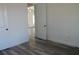 Bright bedroom with wood floors and a view to the main entrance at 13055 Ne 7Th Loop, Silver Springs, FL 34488