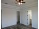 Bedroom featuring gray wood floors, walk-in closet, and a bathroom at 13055 Ne 7Th Loop, Silver Springs, FL 34488