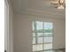 Bedroom with sliding glass doors leading to a deck overlooking a lake at 13055 Ne 7Th Loop, Silver Springs, FL 34488