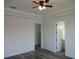 Bedroom featuring gray wood floors, walk-in closet, and a bathroom at 13055 Ne 7Th Loop, Silver Springs, FL 34488