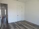 Bedroom featuring luxury vinyl plank flooring and two closets at 13055 Ne 7Th Loop, Silver Springs, FL 34488