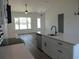 Kitchen featuring stainless steel appliances, white cabinets, and hardwood floors at 13055 Ne 7Th Loop, Silver Springs, FL 34488