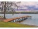 Long wooden dock extending into the lake at 13055 Ne 7Th Loop, Silver Springs, FL 34488