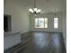 Open concept living room featuring wood floors, a fan and many windows for natural light at 13055 Ne 7Th Loop, Silver Springs, FL 34488