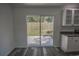 View of backyard through sliding glass doors from kitchen at 13099 Ne 7 Loop, Silver Springs, FL 34488