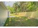 Landscaped backyard with wooden privacy fence at 13099 Ne 7 Loop, Silver Springs, FL 34488