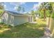 House exterior showcasing backyard access and a wooden privacy fence at 13099 Ne 7 Loop, Silver Springs, FL 34488