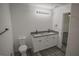 Bathroom with double vanity, gray countertop, and gray flooring at 13099 Ne 7 Loop, Silver Springs, FL 34488