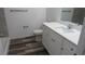 Bright bathroom featuring an updated vanity with white cabinets and solid surface countertop at 13099 Ne 7 Loop, Silver Springs, FL 34488