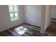 Bedroom with wood-look flooring, a window, and white walls, creating a bright space at 13099 Ne 7 Loop, Silver Springs, FL 34488