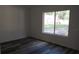 Bedroom featuring wood-look flooring, a window, and neutral walls at 13099 Ne 7 Loop, Silver Springs, FL 34488