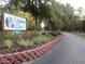 Entrance sign displays the community name, 'Lakeview Woods,' amidst lush landscaping at 13099 Ne 7 Loop, Silver Springs, FL 34488