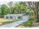 Newly constructed home with gray siding, white garage door, and a paved driveway at 13099 Ne 7 Loop, Silver Springs, FL 34488