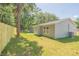 Newly built home with gray siding and a fenced backyard at 13099 Ne 7 Loop, Silver Springs, FL 34488