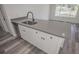 Kitchen island with gray countertop and stainless steel sink at 13099 Ne 7 Loop, Silver Springs, FL 34488