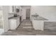 Modern kitchen with gray countertops and white cabinets at 13099 Ne 7 Loop, Silver Springs, FL 34488