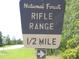 Clear sign indicating the location of the National Forest Rifle Range 1/2 mile ahead at 13099 Ne 7 Loop, Silver Springs, FL 34488