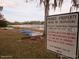 Picturesque waterfront scene shows boats on the shore, near a sign indicating 'Private Property' at 13099 Ne 7 Loop, Silver Springs, FL 34488