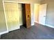 Bedroom with double door closet and gray vinyl flooring at 13380 Se 43Rd Ave, Belleview, FL 34420