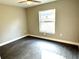 Spacious bedroom with large window and dark gray vinyl flooring at 13380 Se 43Rd Ave, Belleview, FL 34420