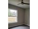 Spacious bedroom with large window and ceiling fan at 13380 Se 43Rd Ave, Belleview, FL 34420