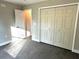 Bedroom with double door closet and gray vinyl flooring at 13380 Se 43Rd Ave, Belleview, FL 34420