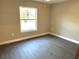 Bright bedroom with large window and gray vinyl flooring at 13380 Se 43Rd Ave, Belleview, FL 34420