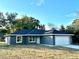 Gray house with a white garage door and a dark gray roof at 13380 Se 43Rd Ave, Belleview, FL 34420