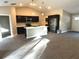 Open concept kitchen with island, stainless steel appliances, and dark cabinets at 13380 Se 43Rd Ave, Belleview, FL 34420