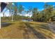 View of backyard with mature trees and neighboring homes at 14363 Se 36Th Ct, Summerfield, FL 34491