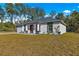 Newly built home featuring a gray roof, white exterior, and a spacious yard at 14363 Se 36Th Ct, Summerfield, FL 34491