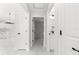 Clean hallway with white doors and marble floors at 14363 Se 36Th Ct, Summerfield, FL 34491